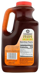Pouring Kikkoman orange sauce over a sizzling stir-fry for glossy coating