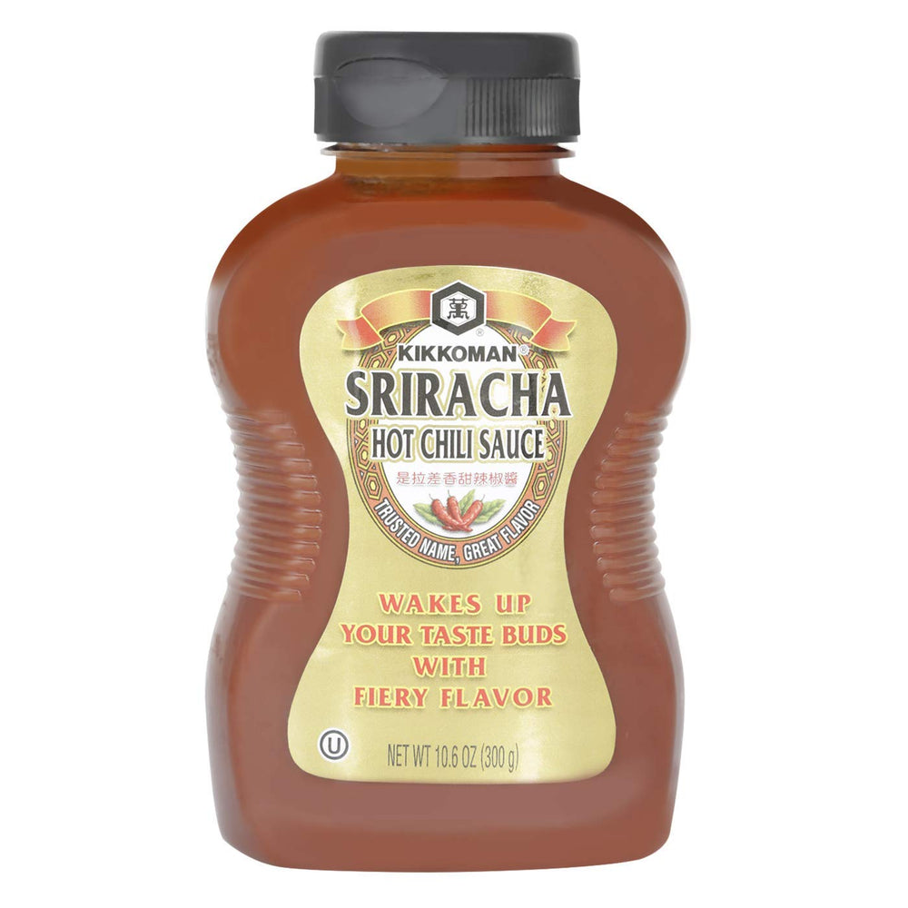 Kikkoman Sriracha sauce bottle pouring over fries for a spicy, flavorful bite.
