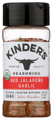 KINDER'S Organic Red Jalapeño & Garlic seasoning bottle on kitchen counter for bold flavor.