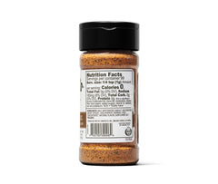 Kinder's Woodfired Garlic Rub spoon-dusting on meat for aroma