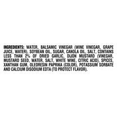 Kraft Balsamic Vinaigrette being poured over a fresh salad