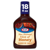 Kraft Hint of Honey BBQ sauce bottle with label, ready to glaze grilled chicken with sweet tang