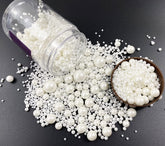 Kuting edible pearl sugar sprinkles in a shaker jar for festive cake decorating