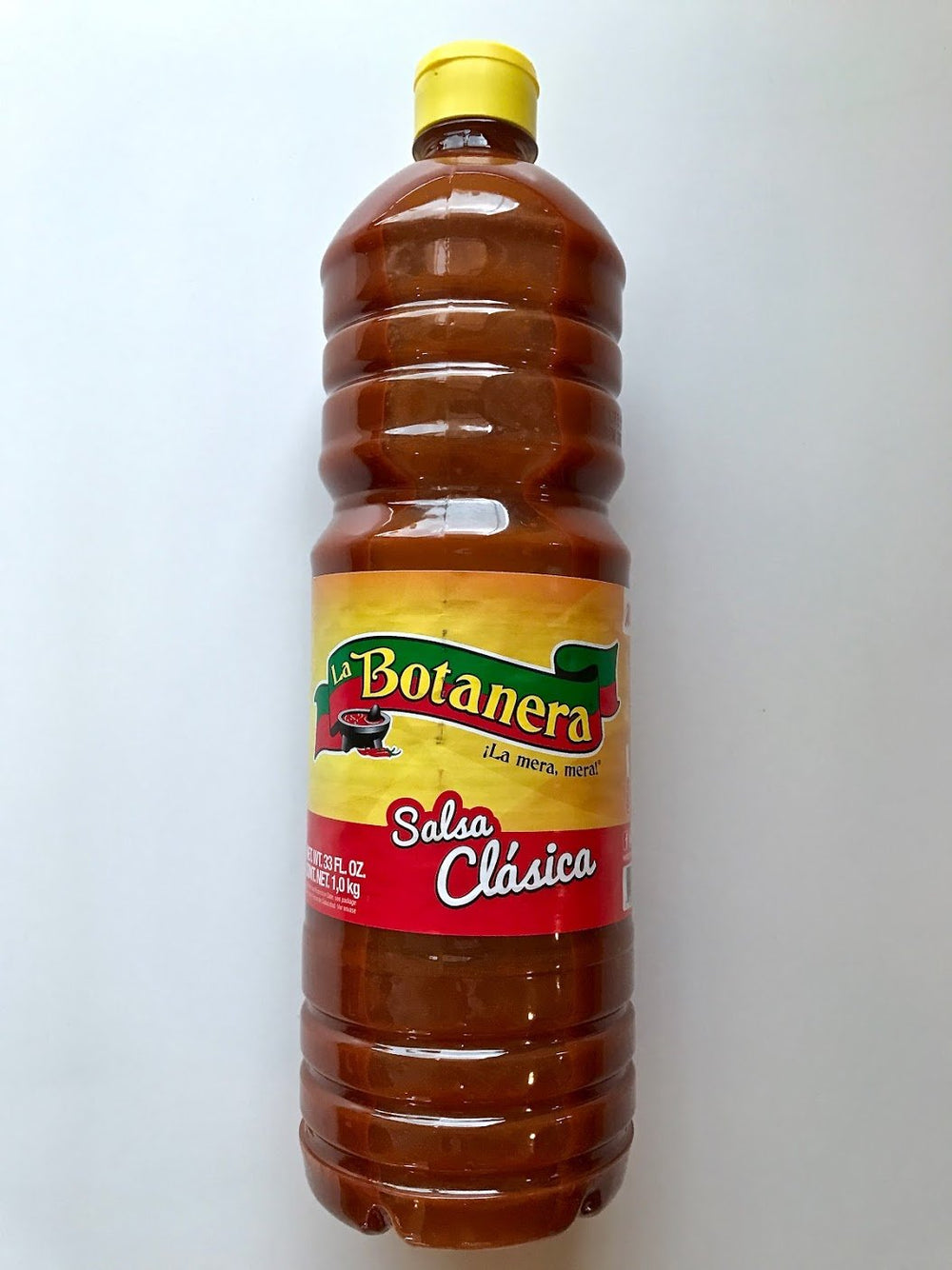 La Botanera Clasica hot sauce bottle, red, adds bold flavor to grilled meats and tacos.