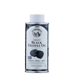 La Tourangelle Black Truffle Oil bottle pouring over pasta for rich aroma.