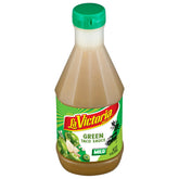 La Victoria Green Taco Sauce Mild bottle on kitchen counter, perfect for topping tacos.