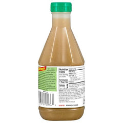 La Victoria Green Taco Sauce Mild bottle with peppers in background, family-friendly heat.