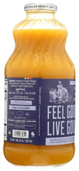 Lakewood Mango Nectar being poured from a glass bottle into a glass
