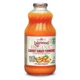 Lakewood carrot-ginger-turmeric juice bottle on a kitchen counter highlights pasteurized, organic ingredients.