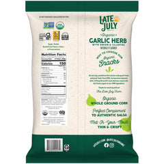Chips with salsa for dipping featuring Late July Garlic Herb Tortilla Chips.