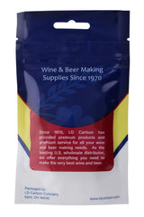 Crushed LD Carlson Campden tablet being mixed into wine for even distribution.