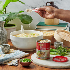Lee Kum Kee Chicken Bouillon Powder closeup scoop enables savory base building.
