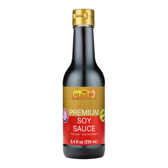 Lee Kum Kee Premium Soy Sauce bottle being poured for rich flavor.