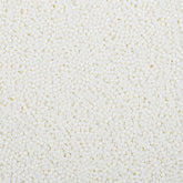 LittleStar white 2mm nonpareils sprinkled on frosted cake for a festive finish