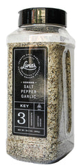 Livia's Salt Pepper Garlic Seasoning bottle enhances steaks with bold, savory aroma.
