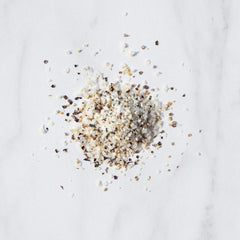 Livia's Salt Pepper Garlic Seasoning grinder shown in action for peppery crusts.