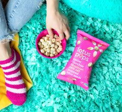 Lotus Pops held in hand, perfect for on-the-go.