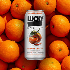 Lucky Energy Orange Drizzle being poured into a glass for on-the-go energy.