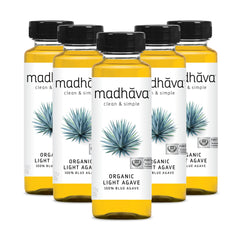 Madhava Organic Light Agave Nectar bottle on counter, ideal natural sweetener for beverages.