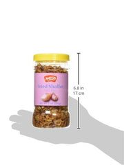 Maesri fried shallots on dish, enhances flavor with savory crunch.