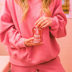 Mamma Chia Strawberry Lemonade prebiotic squeeze snack pour-into-cup in use.