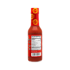 Pour shot of Marie Sharp's Red Hornet adding fiery depth to any dish