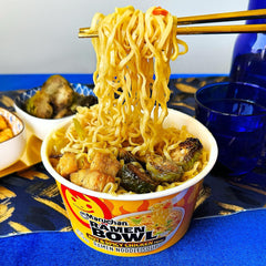 Maruchan Bowl hot and spicy chicken ingredients with chili and vegetables visible.