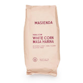 Masienda Heirloom White Corn Masa Harina bag shown on a wooden surface for authentic tortillas and tamales.