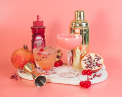 Master of Mixes Grenadine ingredients close-up, highlighting pomegranate and cherry juice.