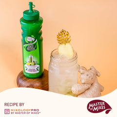 Lime juice beside margarita glass with salt rim