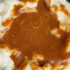 Gravy simmering on the stovetop with McCormick mix
