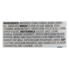 Stirring McCormick Country Gravy for a smooth, lump-free texture.