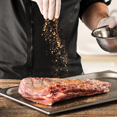 McCormick Grill Mates Smokehouse Maple sprinkled on chicken for robust flavor