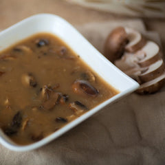 McCormick Mushroom Gravy Mix simmering into a smooth sauce in a pan.