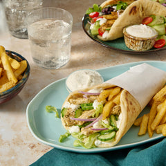 Pita bread being wrapped with McCormick gyro filling for a complete meal.