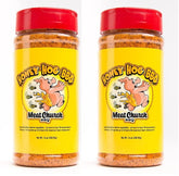 Meat Church Honey Hog rub bottles pouring to season pork and vegetables with sweet heat.