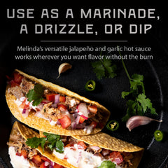 Tacos topped with Melinda's sauce for a vibrant, garlic-forward finish.
