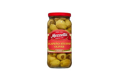 Closeup of glossy olives and jalapeno stuffing with crisp bite.