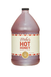 Mike's Hot Honey bottle pouring on pizza to add sweet heat