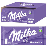 Milka Alpenmilch bar being unwrapped for a smooth melt.