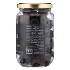 Mina dry cured black olives in jar shown in kitchen setting for fresh taste
