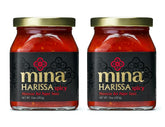 Mina Harissa hot sauce bottle with vibrant red color ready to elevate dishes.
