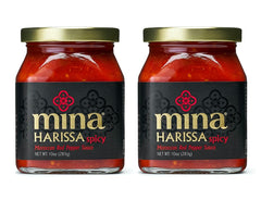 Mina Harissa hot sauce bottle with vibrant red color ready to elevate dishes.
