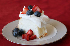 A slice of baked Mom's Place gluten-free angel food cake with delicate crumb