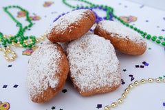 Fresh warm beignets plated using Mom's Place gluten-free mix