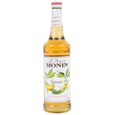 Monin Banana Syrup bottle boosts cocktails with tropical banana flavor.