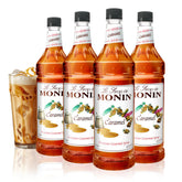 Monin Caramel Syrup bottle being poured into coffee for rich flavor