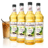 Monin French Vanilla syrup bottle pouring, showcasing smooth vanilla flavor for coffees.