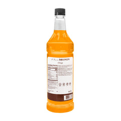 Monin Orange Syrup bottle closeup showcasing rich color.