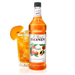 Monin Peach Syrup bottle front view highlighting versatile flavor for iced teas and lemonades